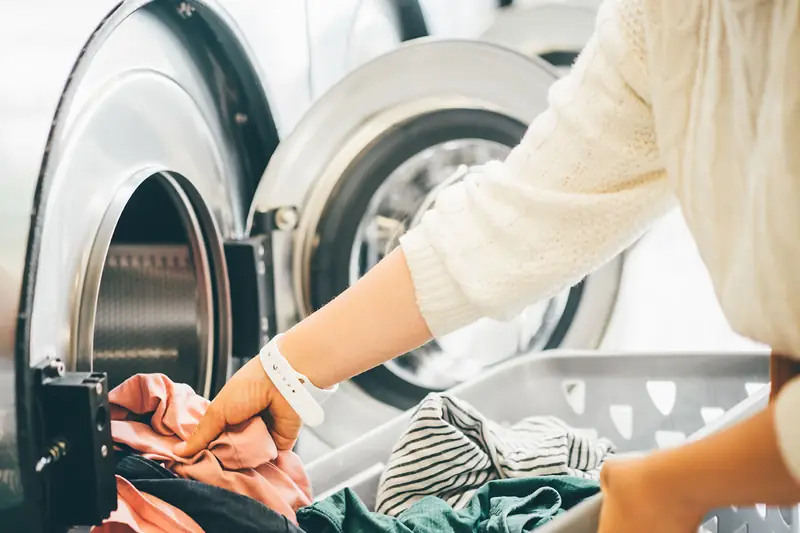 Washing loaded at a laundromat, where a broken machine is a cost that arrives unannounced.